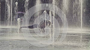 Young woman doing yoga exercises inside the fountain