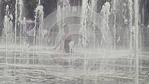 Young woman doing yoga exercises inside the fountain