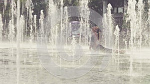 Young woman doing yoga exercises inside the fountain