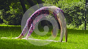 Young woman doing yoga exercises in the park