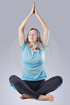 young woman doing yoga exercises. studio photo