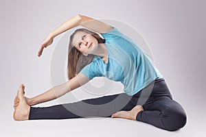 young woman doing yoga exercises. studio photo