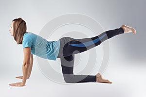 young woman doing yoga exercises. studio photo
