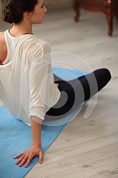 Young Woman Doing Yoga Meditating Relaxing Exercise at home.Healthy Lifestyle. Unrecognizable caucasian female practicing meditati