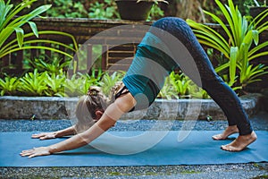 Young woman doing yoga outside in natural environment