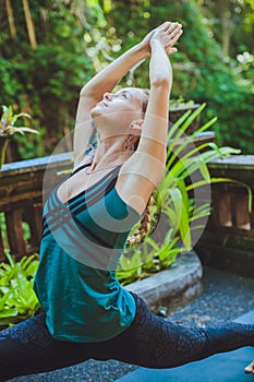 Young woman doing yoga outside in natural environment