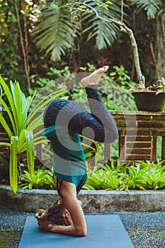 Young woman doing yoga outside in natural environment