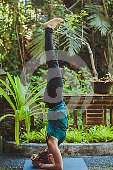 Young woman doing yoga outside in natural environment