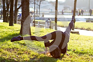 Young woman doing yoga in park