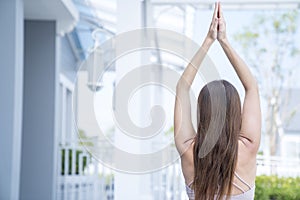 Young woman doing yoga and Pilates outdoor with her mat. Beautiful female happy doing exercise and working out