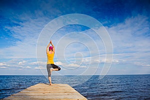 Young woman doing yoga pose