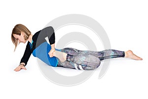 Young woman doing yoga practice isolated on white background. Concept of healthy life and natural balance between body and mental