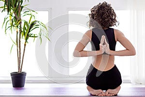Young woman doing yoga workout at home