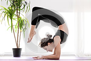 Young woman doing yoga workout at home