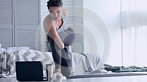 Young woman doing yoga workout at home