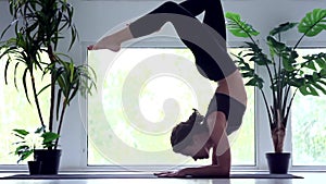 Young woman doing yoga workout at home