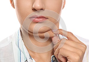 Young woman with double chin on white background