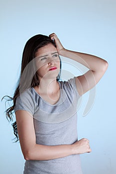 Young woman with doubt expression. Woman scratching her head