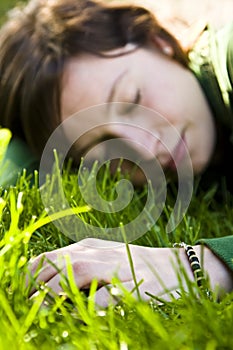 Young woman dreaming in the grass