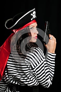 Young woman dressed as a pirate in a black hat hol