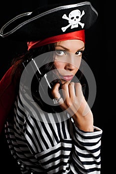 Young woman dressed as a pirate in a black hat hol