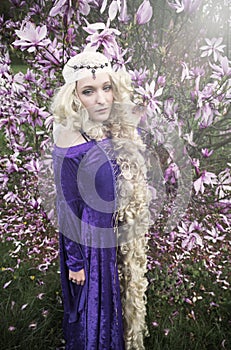 Young woman dressed as Rapunzel in purple gown