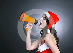 Young woman dressed as Santa Claus shouting into a megaphone