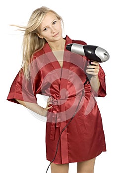 Young woman dressed red bathrobe using hair drier