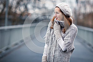 Young woman dressed in a warm woolen cardigan