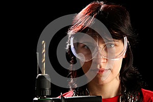 Young woman with drill