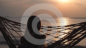 Young Woman Drink Cocktail Swinging in Hammock at Sunset