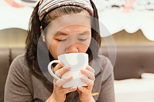 Young woman drink coffee in cafe with vintage tone.