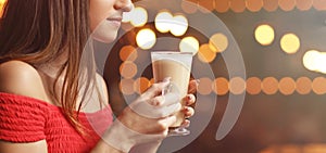 Young woman drinking coffee in a cafe