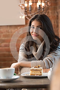 Young woman drinking coffee in a cafe
