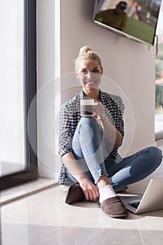 Young woman drinking coffee enjoying relaxing lifestyle