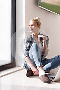 Young woman drinking coffee enjoying relaxing lifestyle