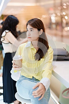 young woman drinking coffee, female hand holding and enjoying a cup of tea at cafe shop