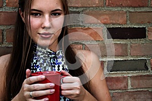 Young Woman Drinking Coffee or Tea