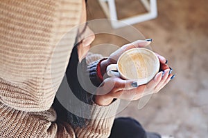 young woman drinking coffee or tea relaxed woman smelling coffee at home in winter with cup coffee, woman coffee with hand holding