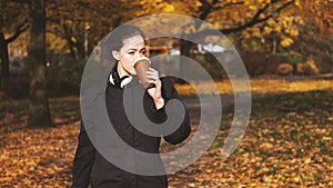 Young woman drinking coffee to go while on the move