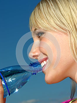 Young woman drinking cold water