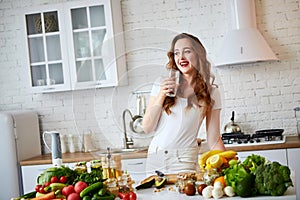 Young woman drinking fresh water from glass in the kitchen. Healthy Lifestyle and Eating. Health, Beauty, Diet Concept