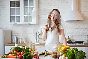 Young woman drinking fresh water from glass in the kitchen. Healthy Lifestyle and Eating. Health, Beauty, Diet Concept