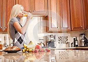 Young Woman Drinking Glass of Orange Juice