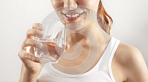 Young woman drinking glass of water