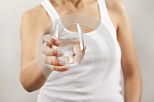 Young woman drinking glass of water