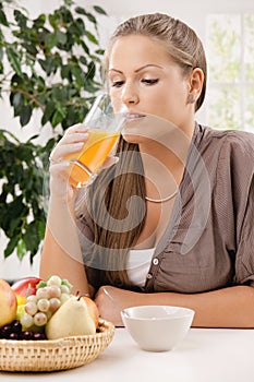 Young woman drinking orange juice