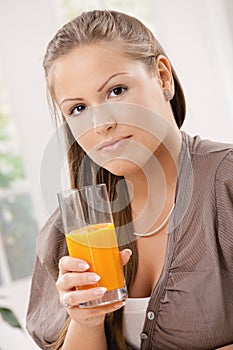 Young woman drinking orange juice