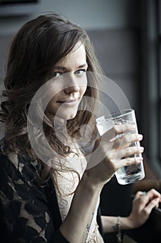 Young Woman Drinking a Pint Glass of Ice Water