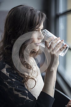 Young Woman Drinking a Pint Glass of Ice Water